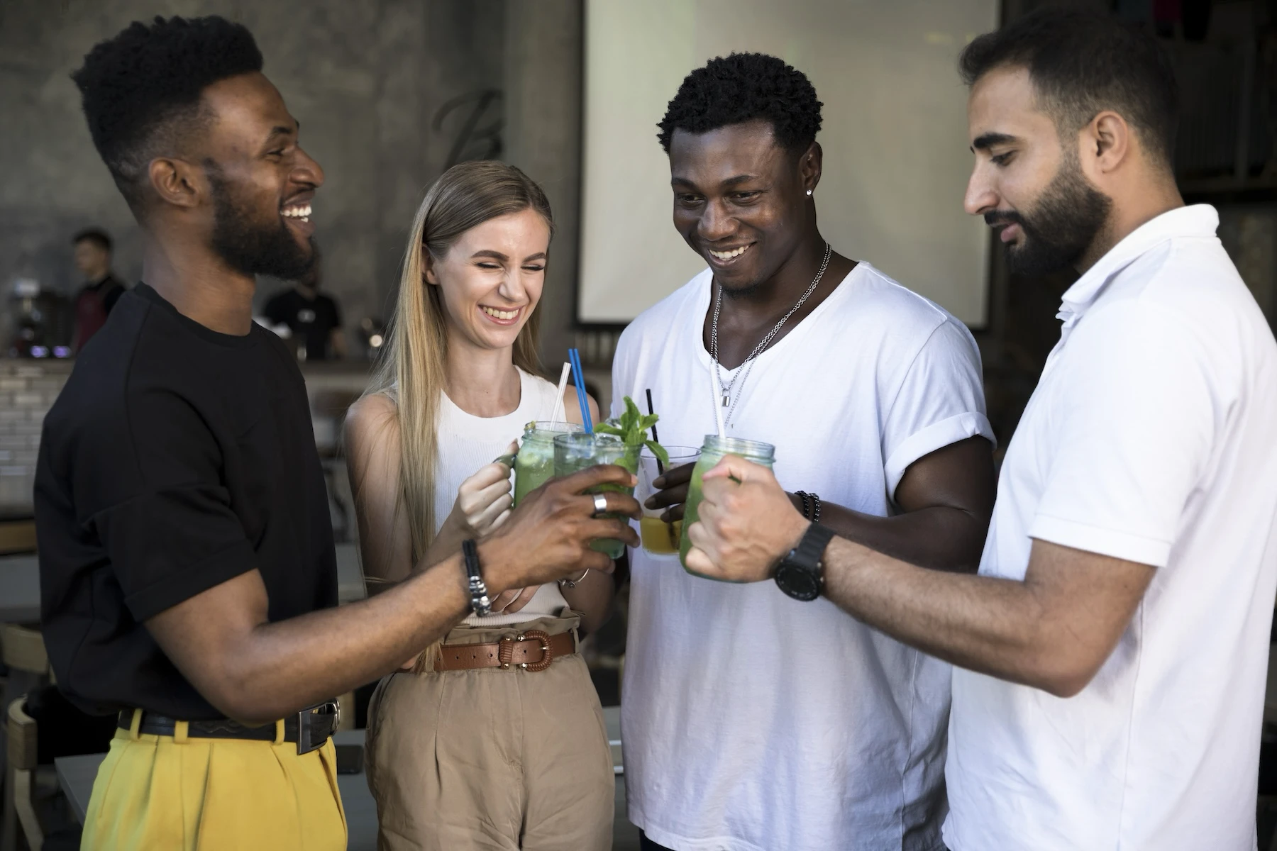 Group of diverse young adults enjoying drinks and socializing at a community event, representing inclusive gatherings hosted by Colorado’s driver-owned rideshare cooperative.
