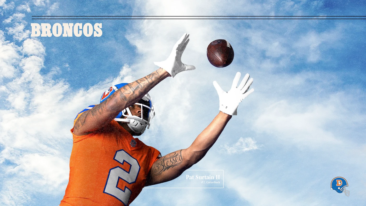Denver Broncos cornerback Pat Surtain II reaching to catch a football against a bright blue sky, wearing orange jersey and white gloves during NFL promotional shoot.